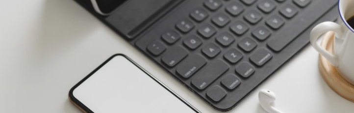 white-smartphone-near-black-keyboard